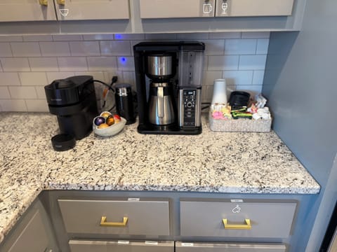 Coffee & tea bar featuring Nespresso Vertuo, milk frother, sugars, creamer, etc