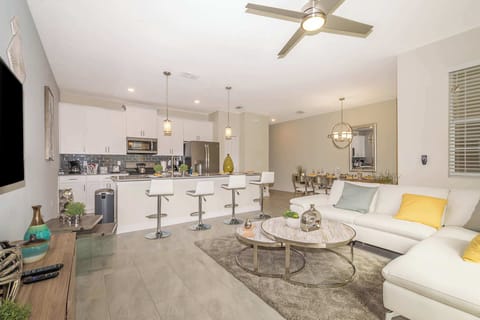 Spacious living room with plush sofas and natural light — relax after Disney adventures in Champions Gate.