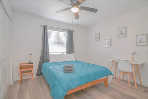 A cozy, queen-sized bed, functional desk, TV, and a spacious wardrobe make this bedroom ideal for remote stays.
