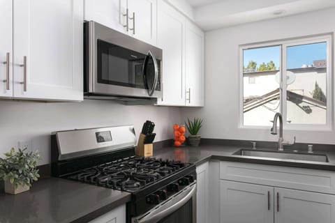 Kitchen view featuring gas stove and ample counter space