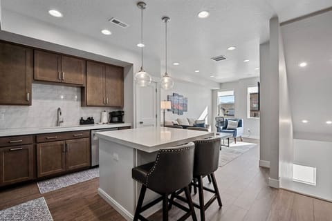 Modern kitchen with bar seating just off living room