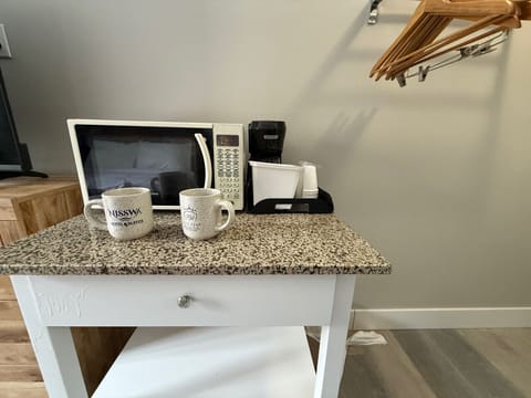 Granite-topped beverage area offering a microwave and coffee maker.