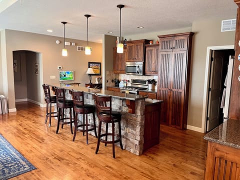 Main floor kitchen area with bar and walk-in pantry.