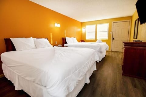 Unwind on crisp double beds in a bright, spacious room.