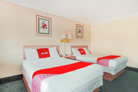 Recharge together with two comfy beds and shared nightstand.