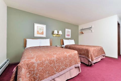Relax in a spacious double-bed room with warm lighting.