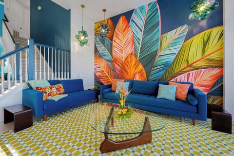 Bold living room with mural art, plush seating & PS5 for post-Disney fun