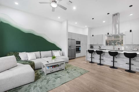 Airy living space w/ comfortable seating and a bold accent wall that adds character without overpowering.