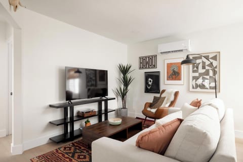 Kick back in the stylish living room, complete with smart TV. Curated art work.
