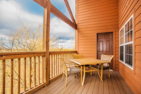 The unit has a private balcony with table and chairs overlooking the surrounding scenery.