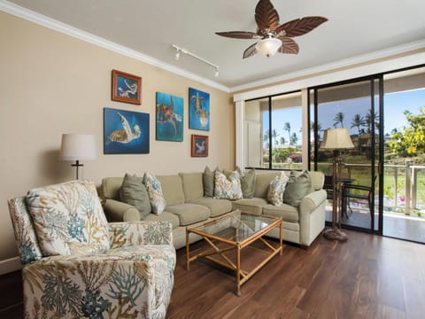 Sink into plush seating adorned with ocean-inspired prints while tropical breezes drift through your open lanai. Your island retreat awaits with comfort and coastal charm at every turn.
