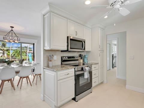 View from the kitchen into the dining area and glimpse of the laundry room