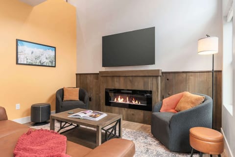 Modern fireplace and warm tones at Wanderlust create the perfect space to relax after a day outside.