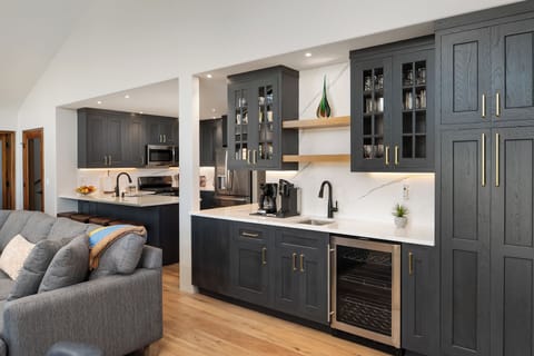 Wet bar complete with wine fridge, sink, and coffee station