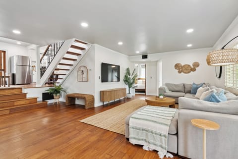Spacious, cozy living room featuring a sectional sofa and smart TV.