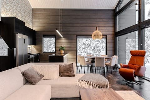 The villa features a fully equipped open kitchen with high-end appliances, a spacious dining table, and all the cookware you need.