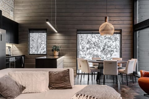 The villa features a fully equipped open kitchen with high-end appliances, a spacious dining table, and all the cookware you need.