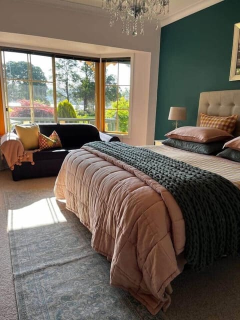 Sun streaming into the bedroom and a beautifully dressed kingsize bed with Belgium linen