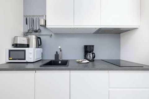 Another kitchen angle showing the stove, microwave, and coffee maker. Perfectly equipped for cooking.