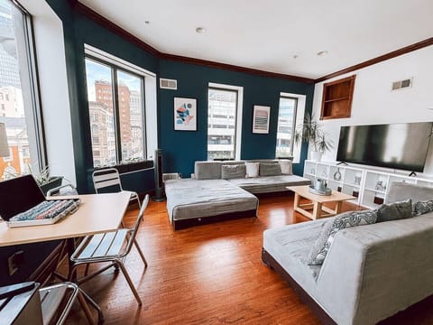 Open-concept living room w/ downtown views & a sleek modern touch