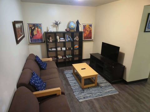 Eclectic living room with reading nook, bookshelves, and international flair