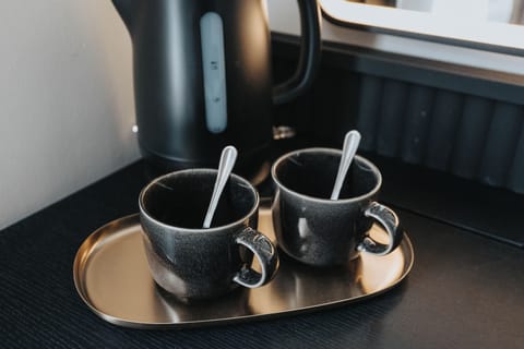 Tea & Coffee Station:
Every room includes its own hotel-style refreshment station with kettle, cups,  tea, coffee, and sugar — a thoughtful touch for guests to enjoy hot drinks and unwind in comfort at any time of day.
