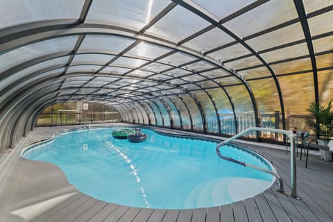 Spacious enclosed pool area with natural light and resort-style ambiance.