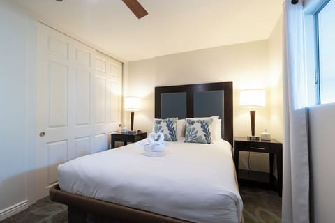 Sink into a cozy queen bed framed by warm bedside glow