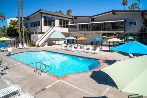 Unwind poolside with plenty of loungers under colorful umbrellas.
