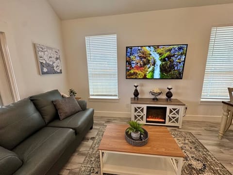 Welcome to the living room where you can relax and watch on big screen tv 55 in