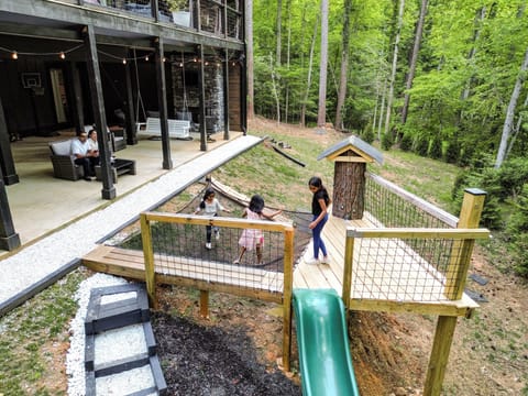 Family-friendly patio and play area surrounded by peaceful forest views