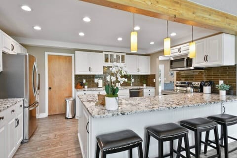 Open kitchen with lots of counter space, the back door to Laundry Room