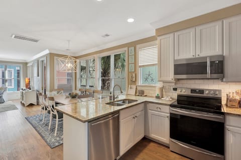 Stocked kitchen with granite countertops and stainless appliances