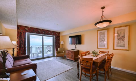Living room with floor-to-ceiling windows and oceanfront views