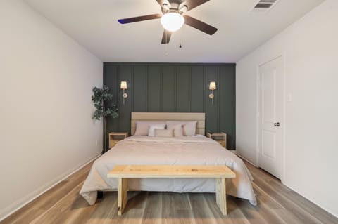 Spacious king bedroom with Smart TV, dedicated workspace and walk-in closet