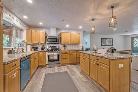 Cook, dine, connect— stocked kitchen, island, coffee and popcorn, dining area