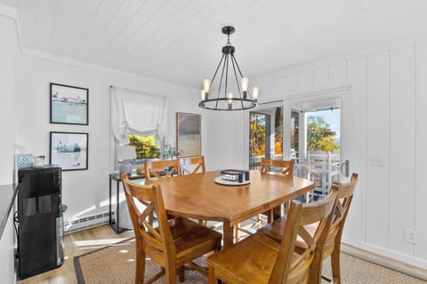 Dining area with a door leading out to the deck.
