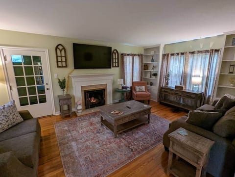 The living room is cozy with a feeling of Home. Enjoy the gas burning fireplace during the cold months, relax on the soft couch or loveseat and watch your high definition 65" Smart TV.