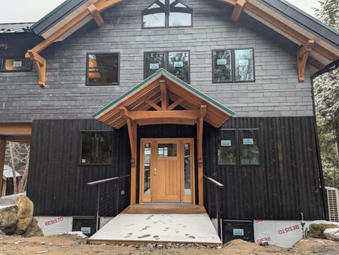 Front door with easy self-check-in. (house has stone on foundation walls now).