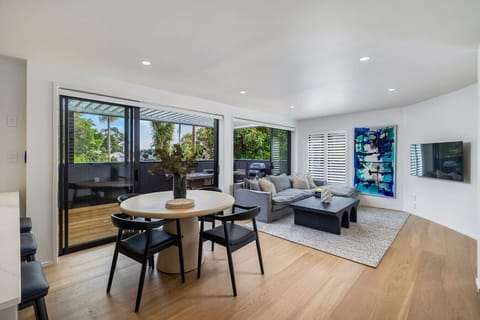 Modern spacious open plan living and dining, leading out to the sunny covered deck with additional dining and BBQ
