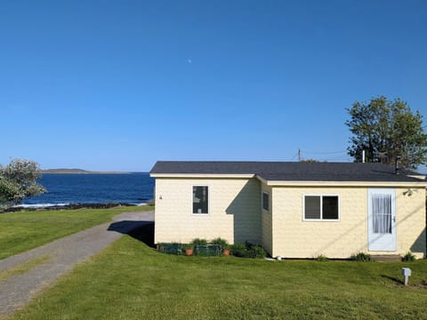 A breathtaking view of the Yellow Cottage overlooking Casco Bay. This property is within steps to it's own private beach.