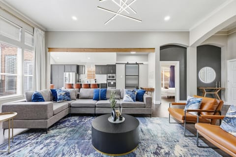 Spacious and open with plenty of natural sunlight, let the calming tones of gray and blue, and playful pops of brown of the living room beckon you to come and stay a while.