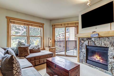 Bright and airy living room with comfortable sectional, Smart TV, and fireplace