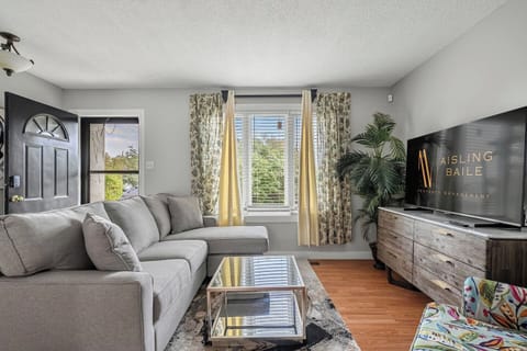 Main floor living room with a 55` Smart TV and a luxurious sectional to kick back on after a day of adventures.