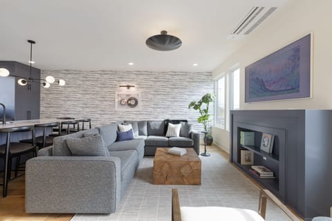 Spacious living room with comfortable seating, modern design, and plenty of natural light.