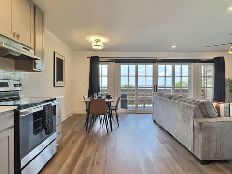 Modern kitchen with a sleek dining area, perfect for cooking, serving, and enjoying meals in style during your short-term rental stay.