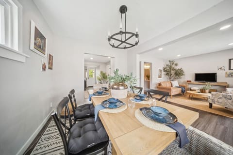 Conveniently located just off the kitchen, the dining space features a beautiful wooden table and an open layout, making it easy to serve meals and stay connected with everyone in the home.