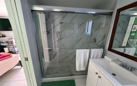 Clean, modern bathroom with walk-in shower and fresh linens.