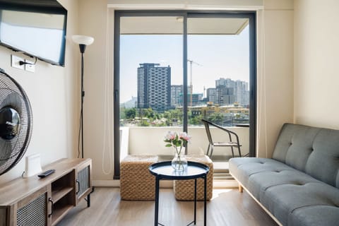 Bright living area with stunning city views, ideal for relaxation and unwinding.