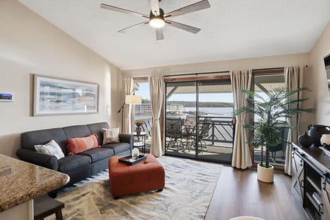 Bright living room with private balcony and beautiful waterfront views